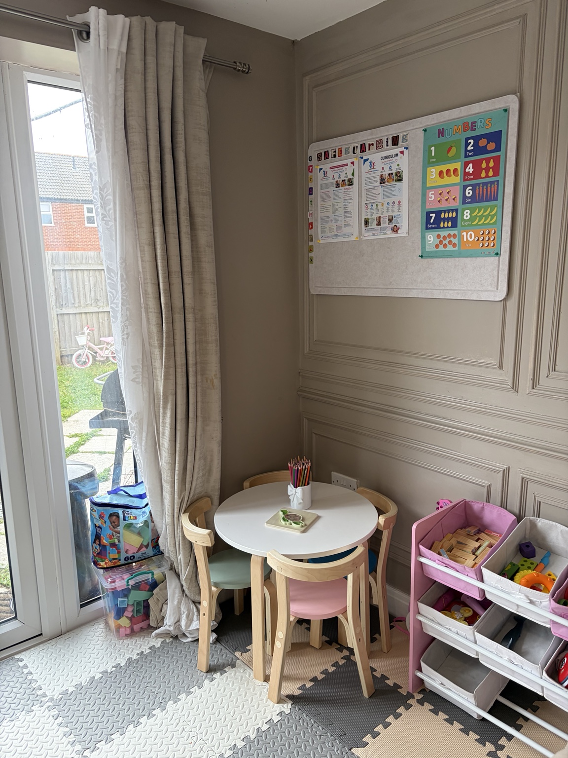 Children's activity table and learning display beside the garden doors